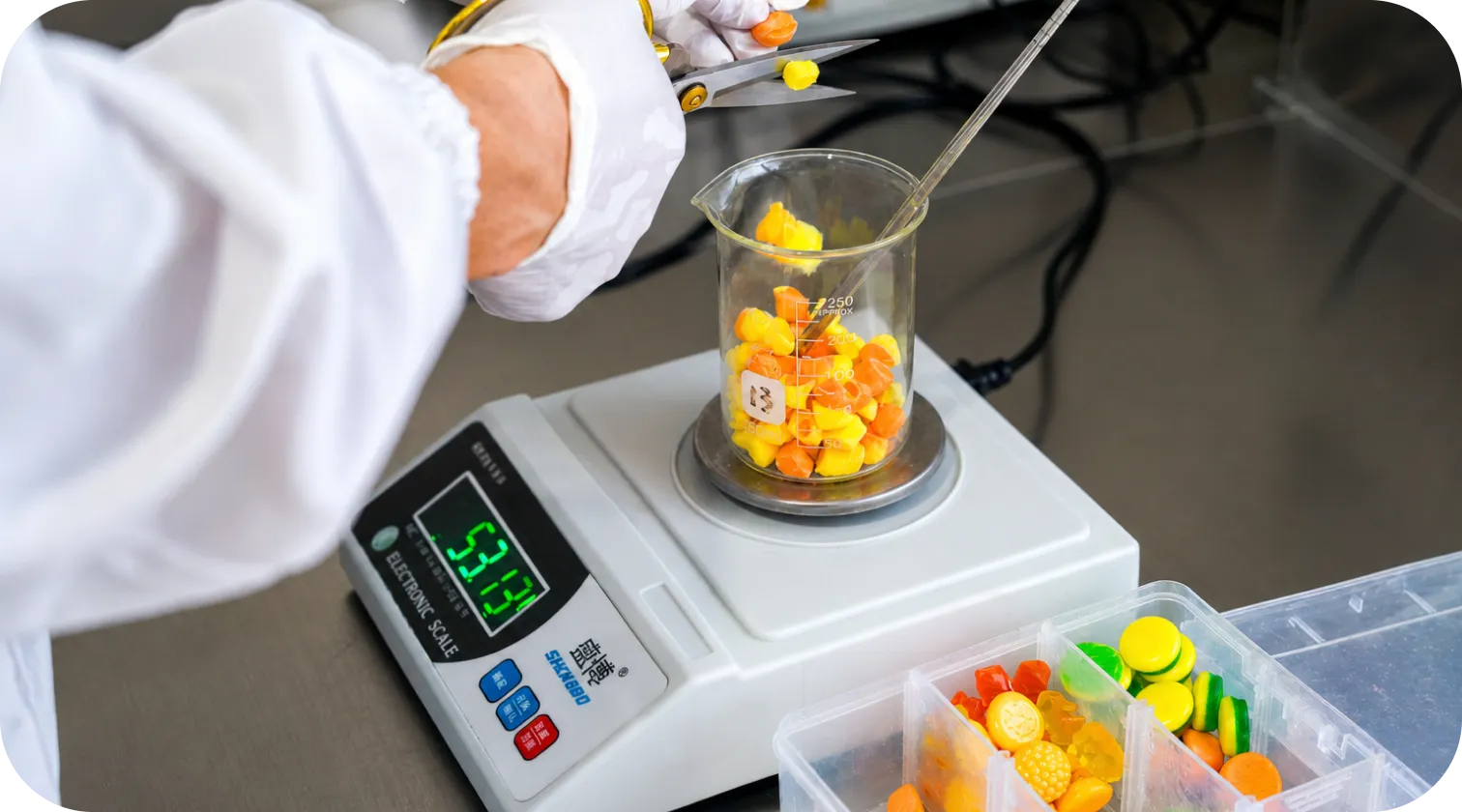 R&D specialist developing gummy formulas on a precision scale